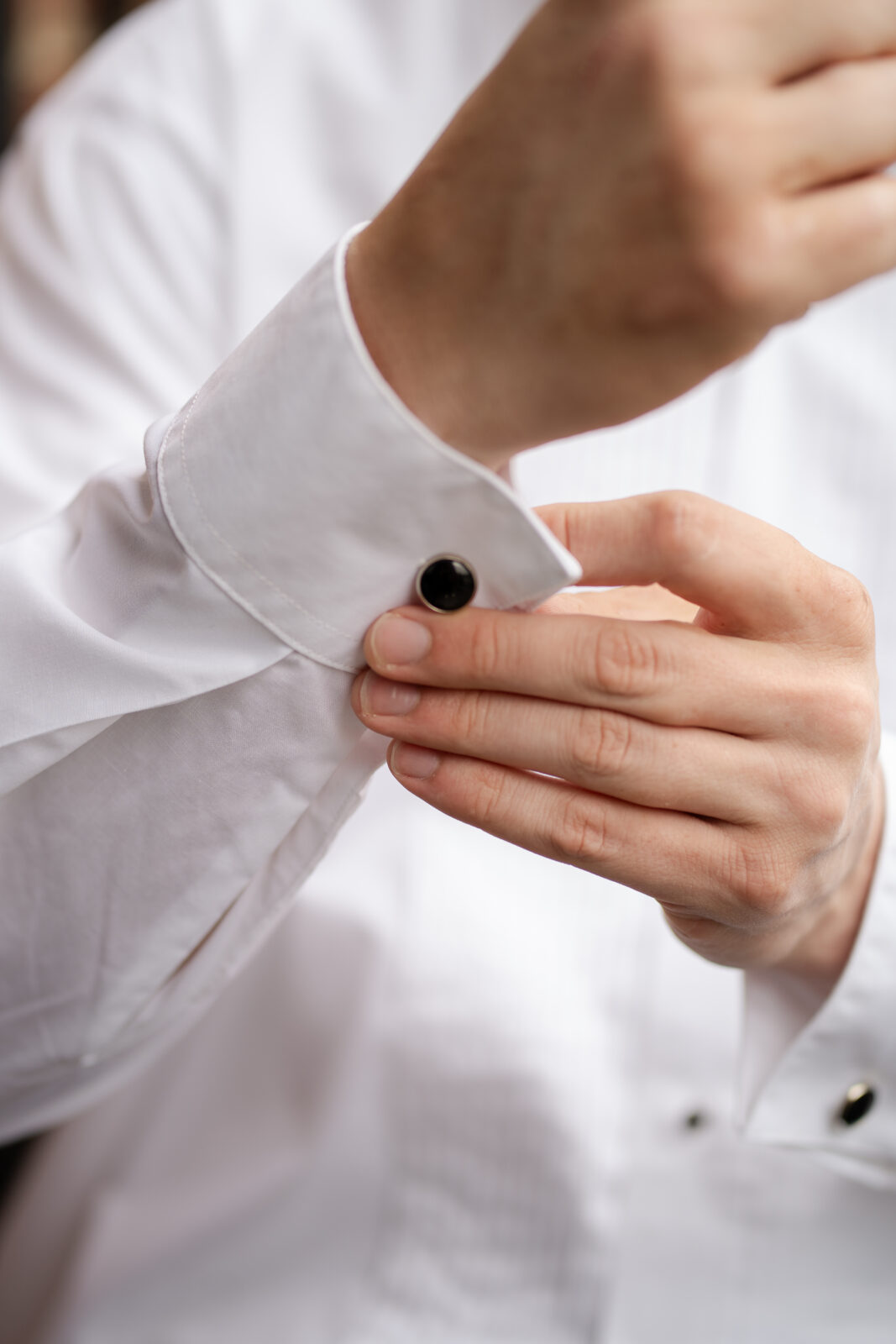 River House groom fixing his cufflinkgs
