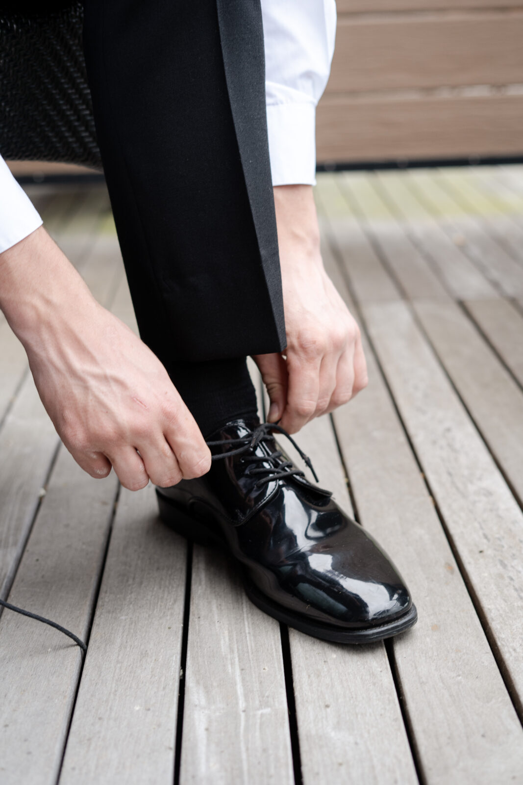 River House groom fixing his shoes