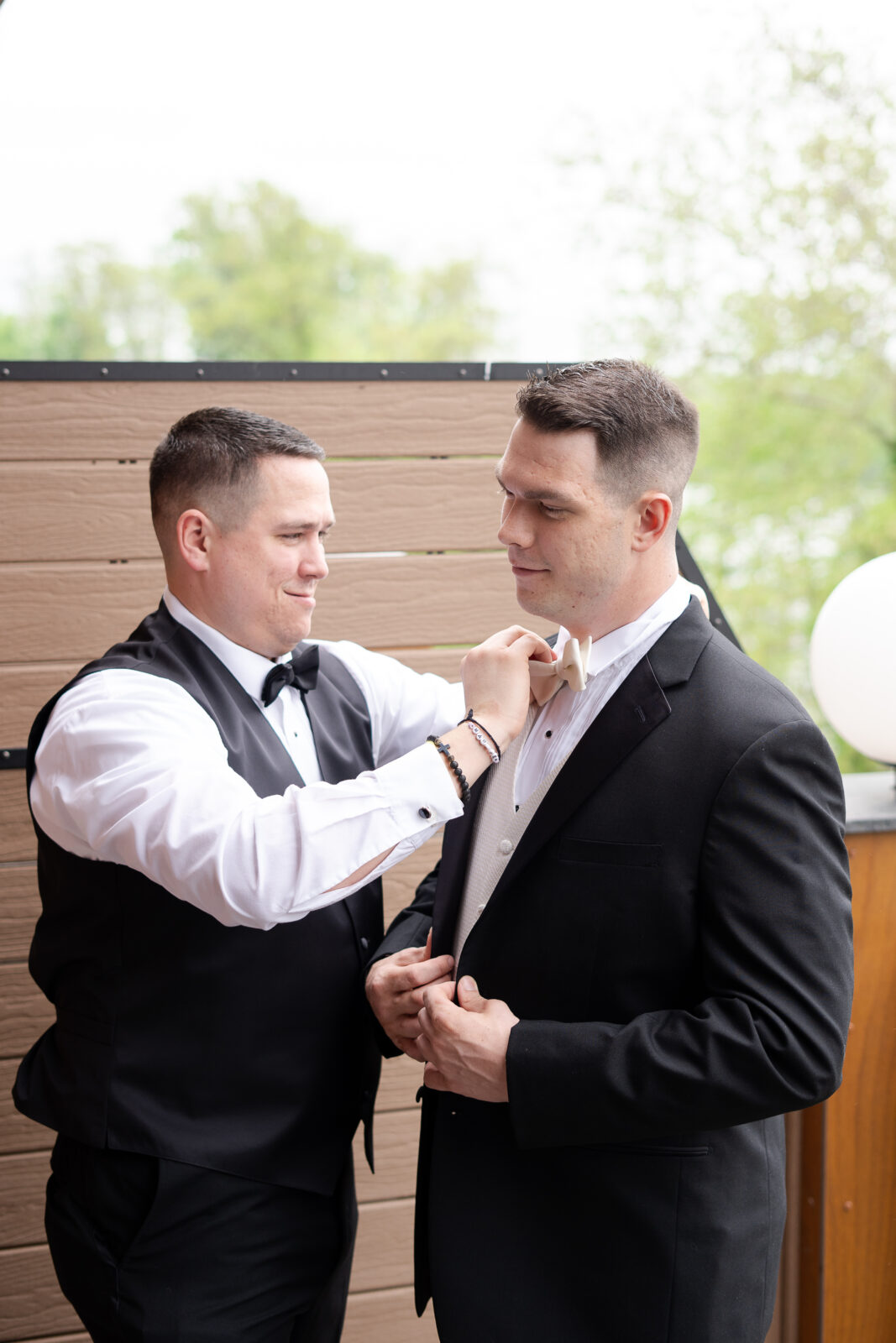 Groom getting dress at groomsmen suite