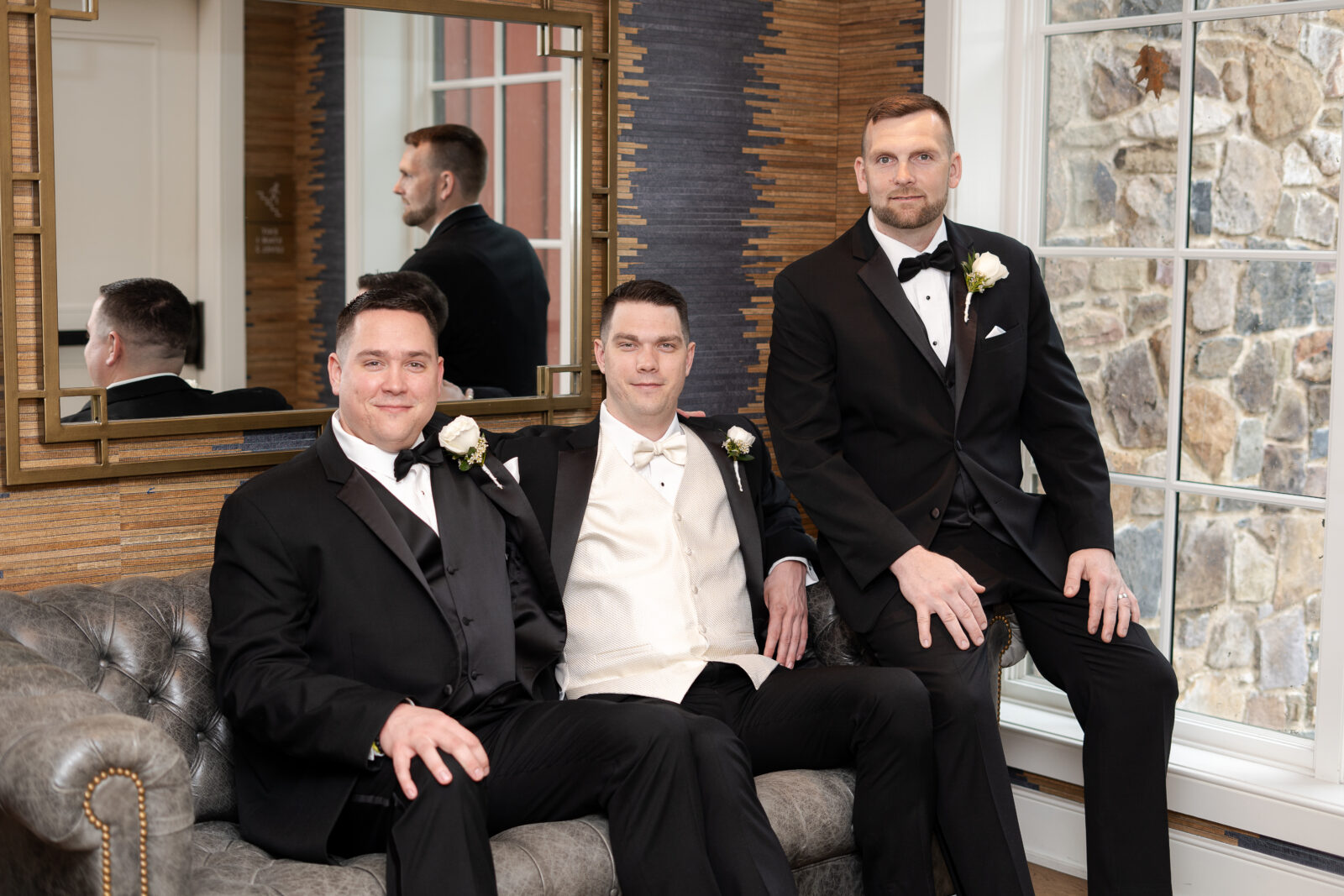 Groom getting dress at groomsmen suite