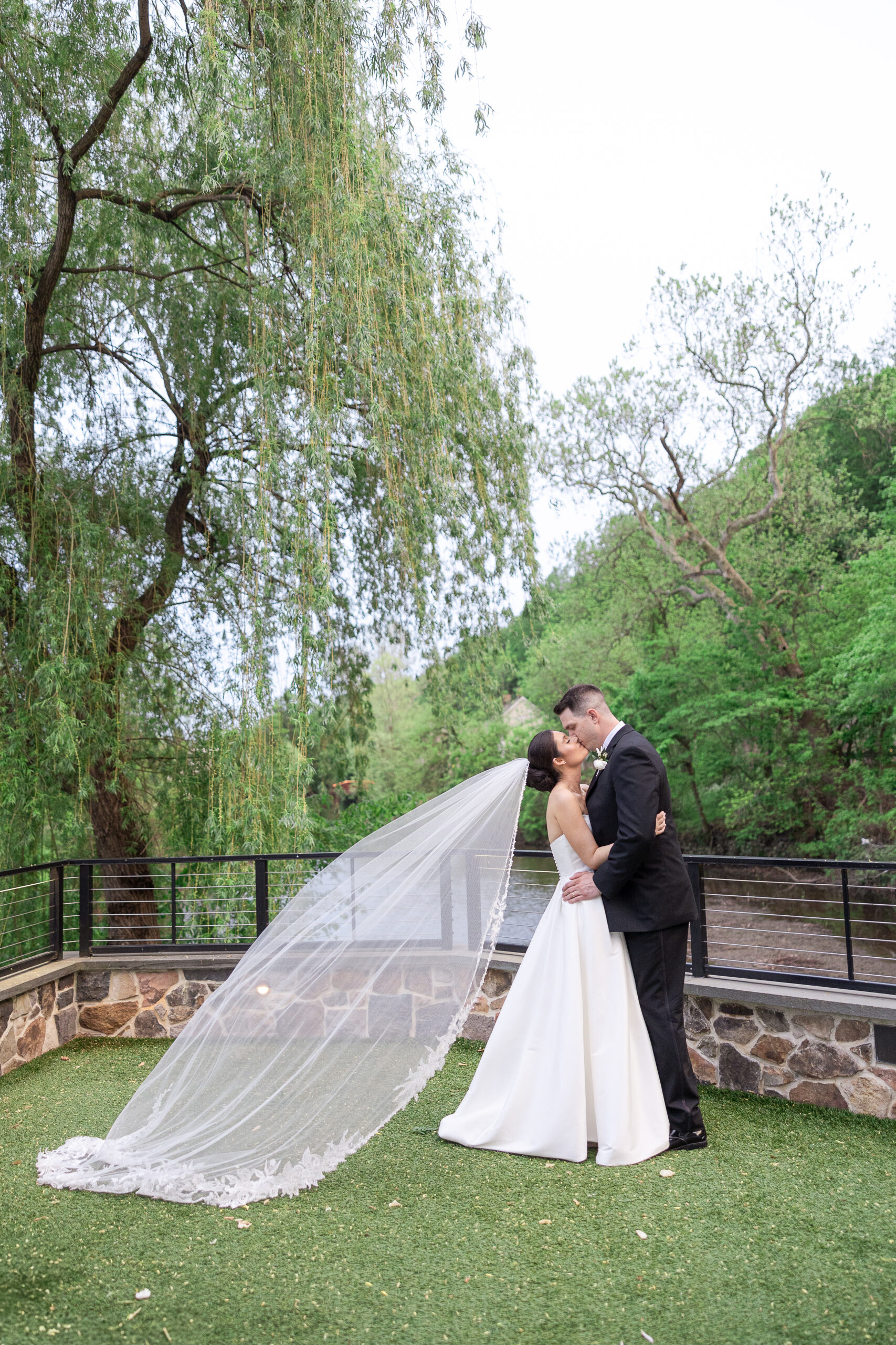 Bride and groom portraits along the Delaware River at River House at Odette’s
