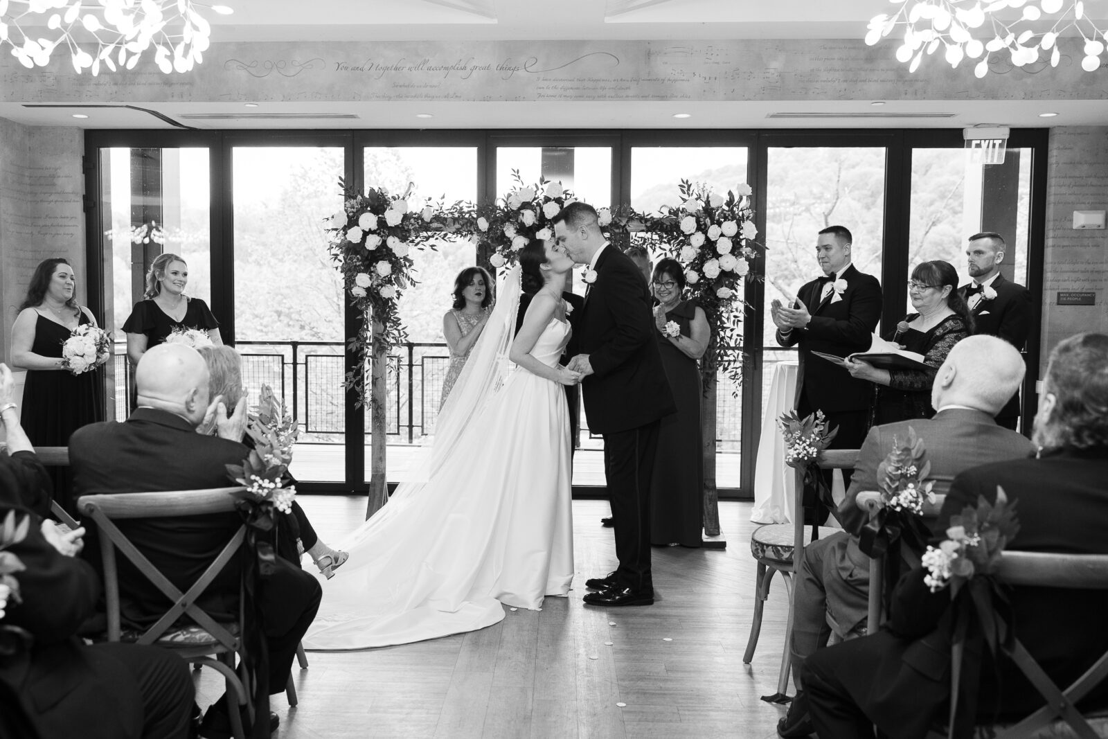 Bride and Groom first kiss at wedding aisle