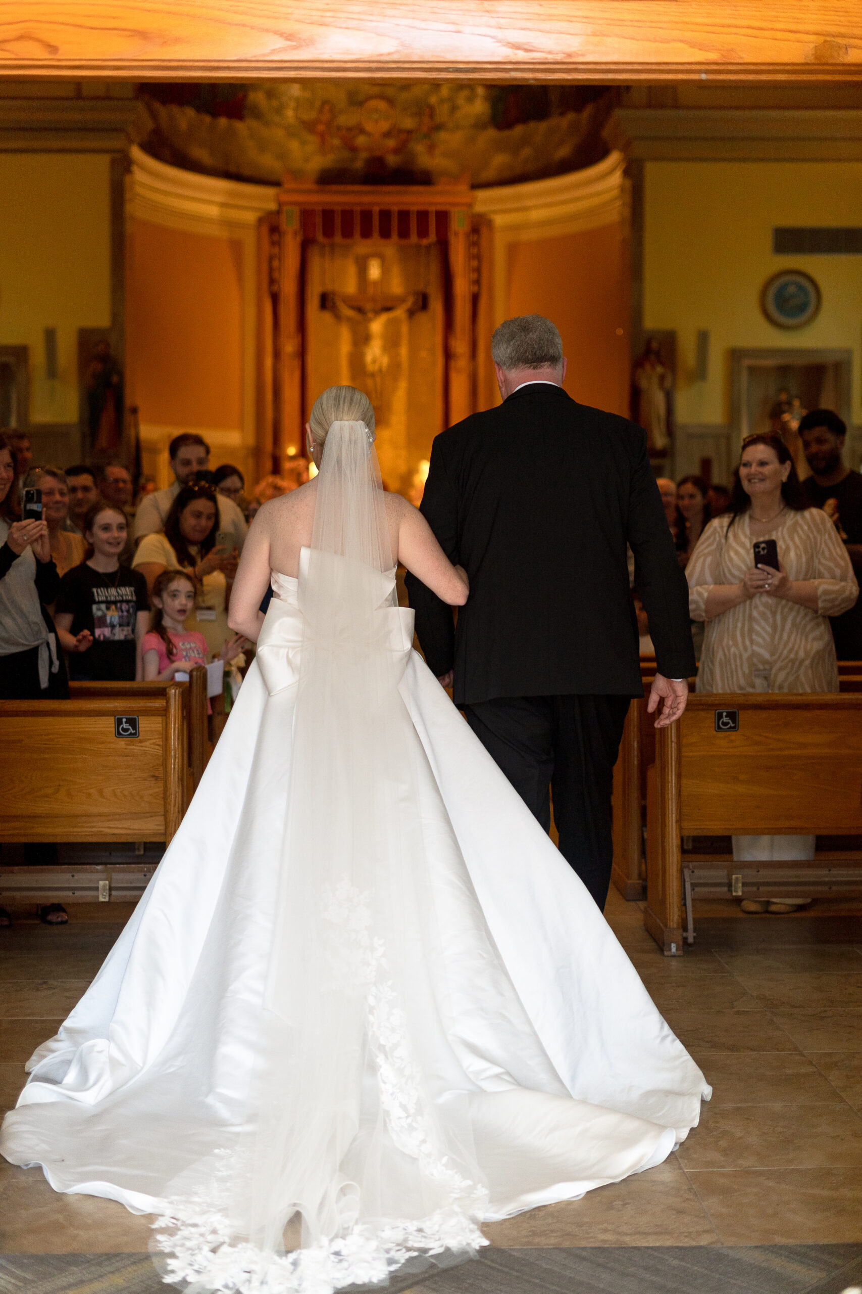 Bride walking down the church aisle during Irish wedding ceremony