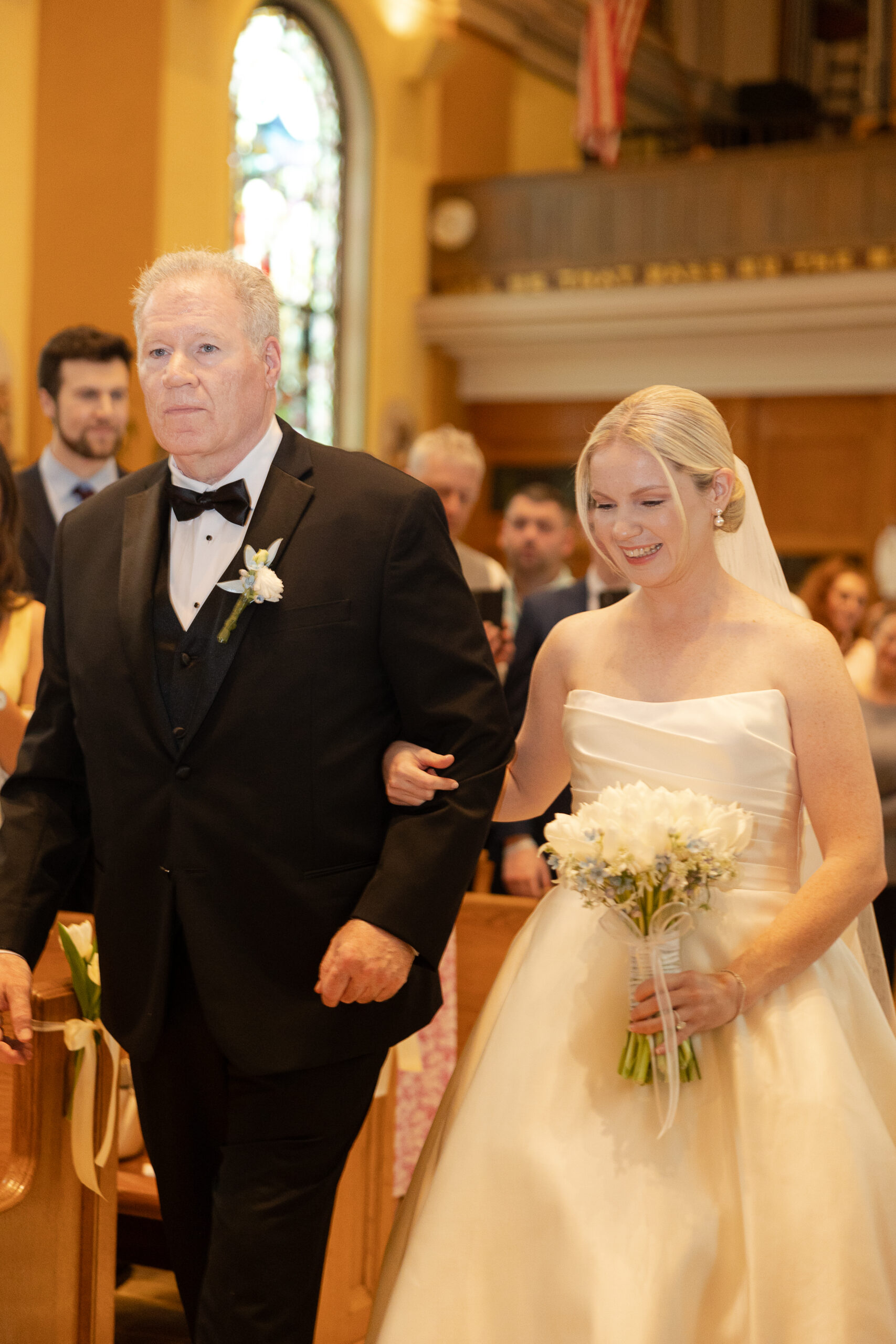 Bride walking down the church aisle during Irish wedding ceremony