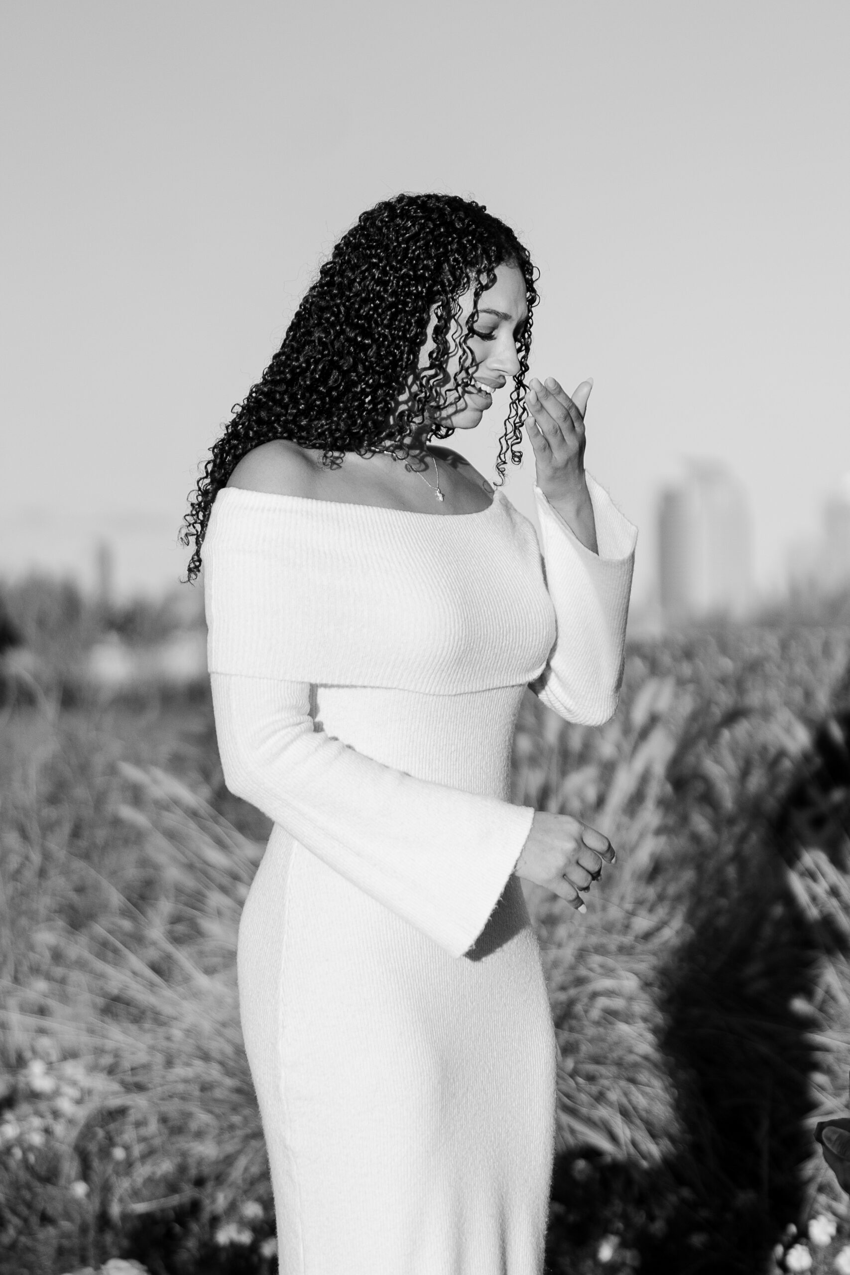 Emotional reaction after a surprise proposal in Jersey City under a white floral arch