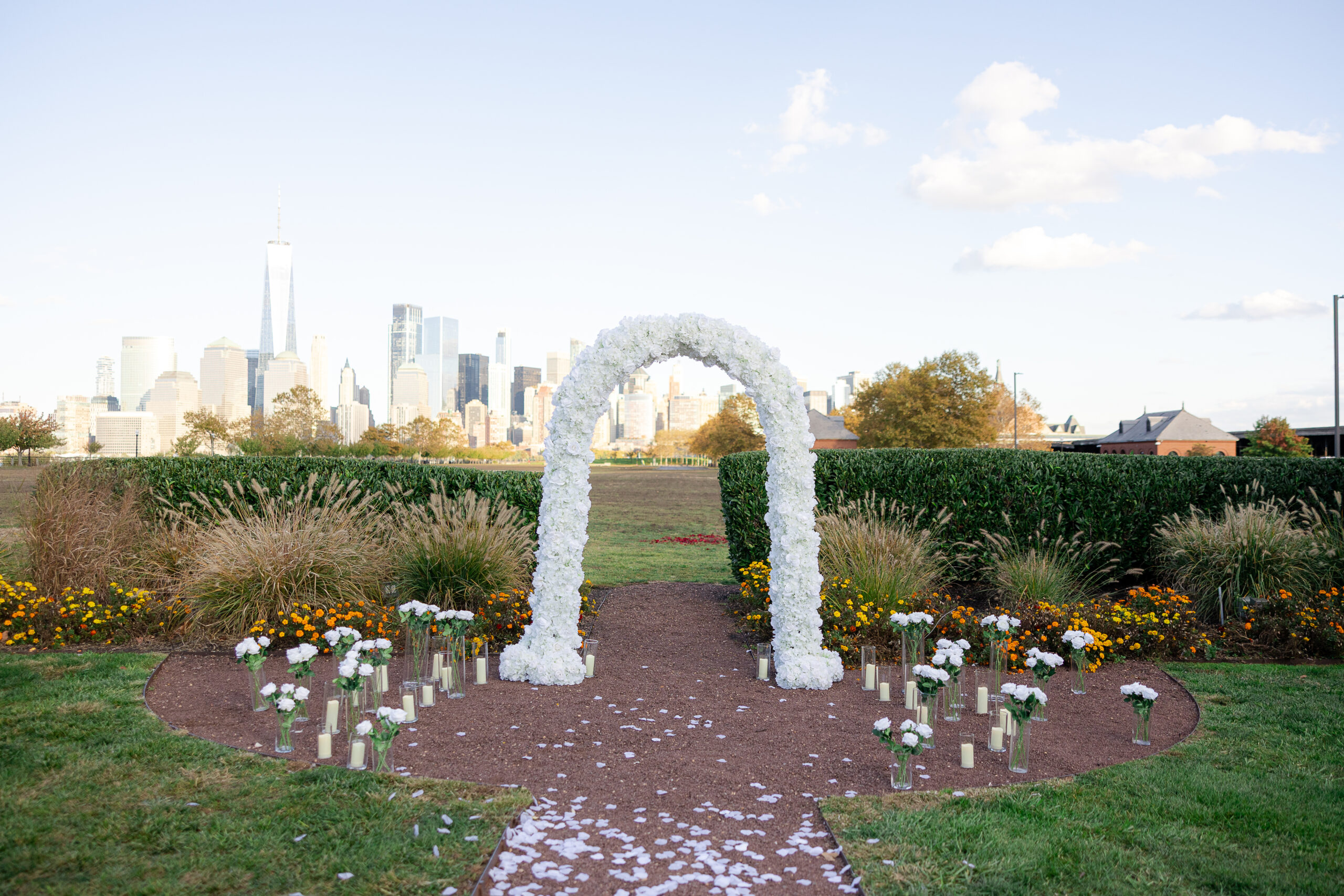 Surprise proposal at Maddy Rose Restaurant in Jersey City with white floral arch and romantic decor