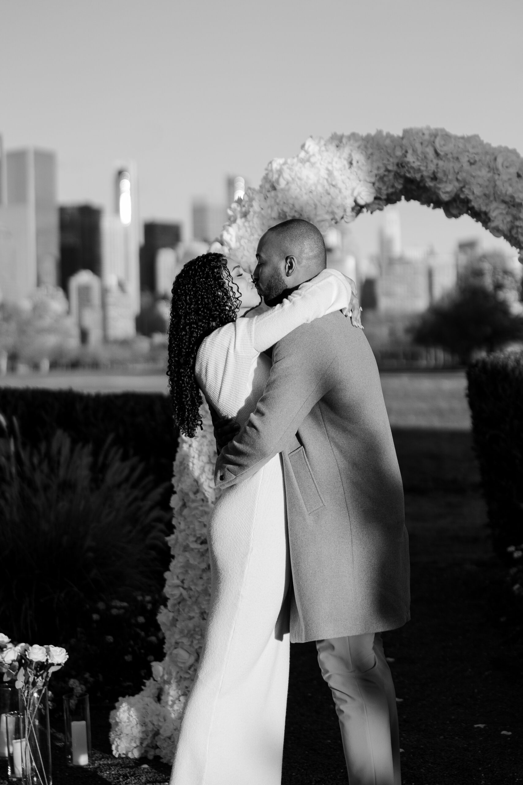 Emotional reaction after a surprise proposal in Jersey City under a white floral arch
