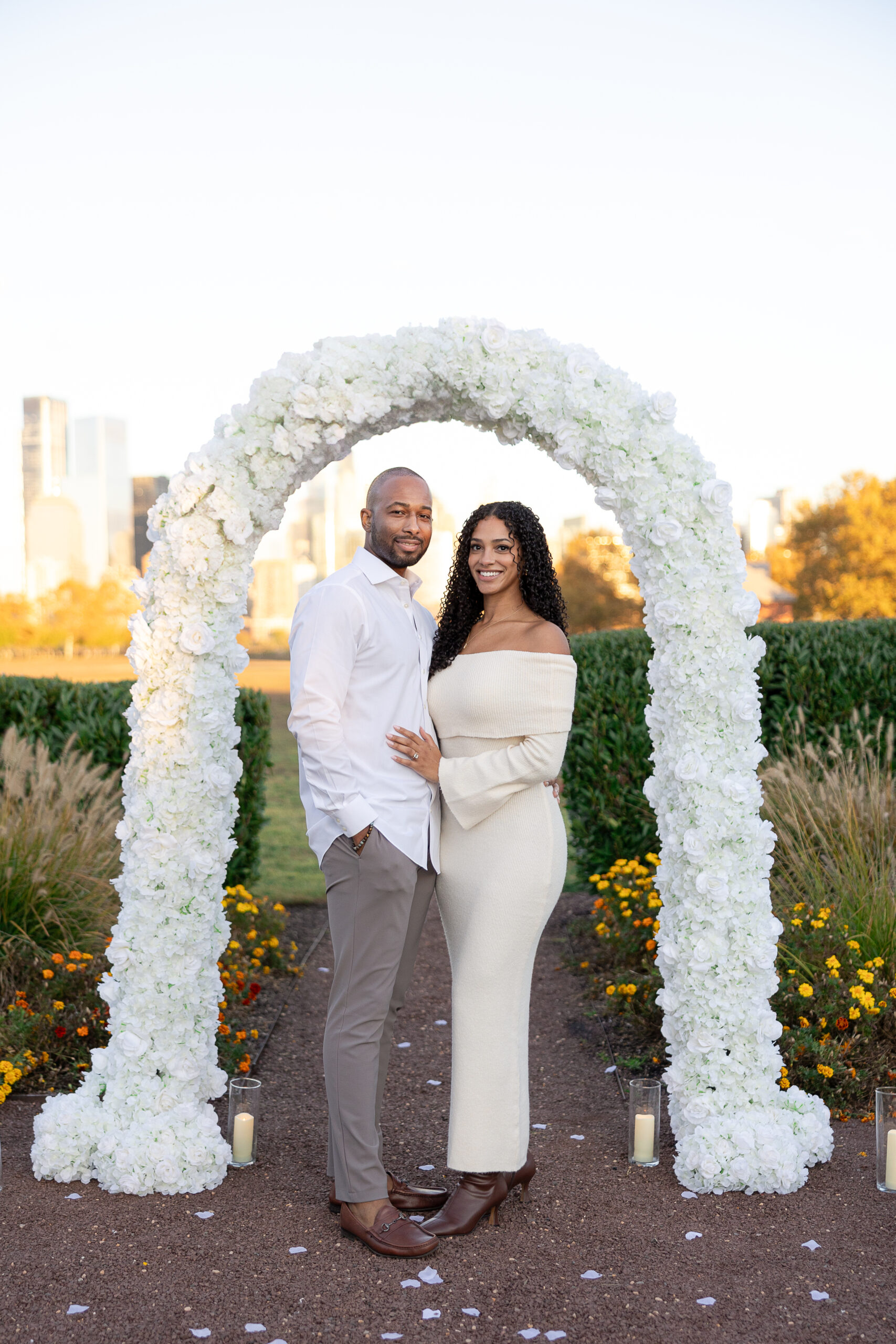 Romantic proposal setup with white floral arch by decor vendor in Jersey City