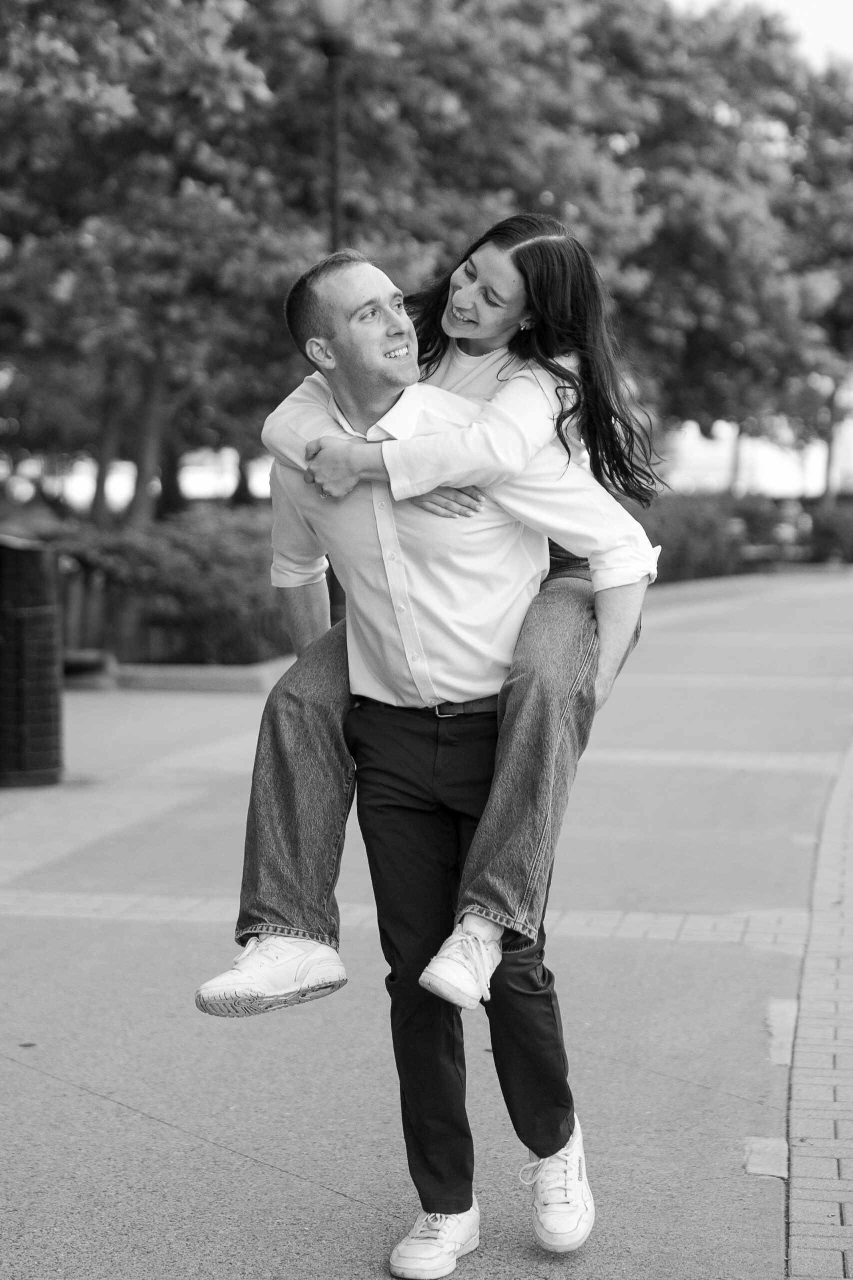 Fun piggy ride portraits of couple in Jersey City