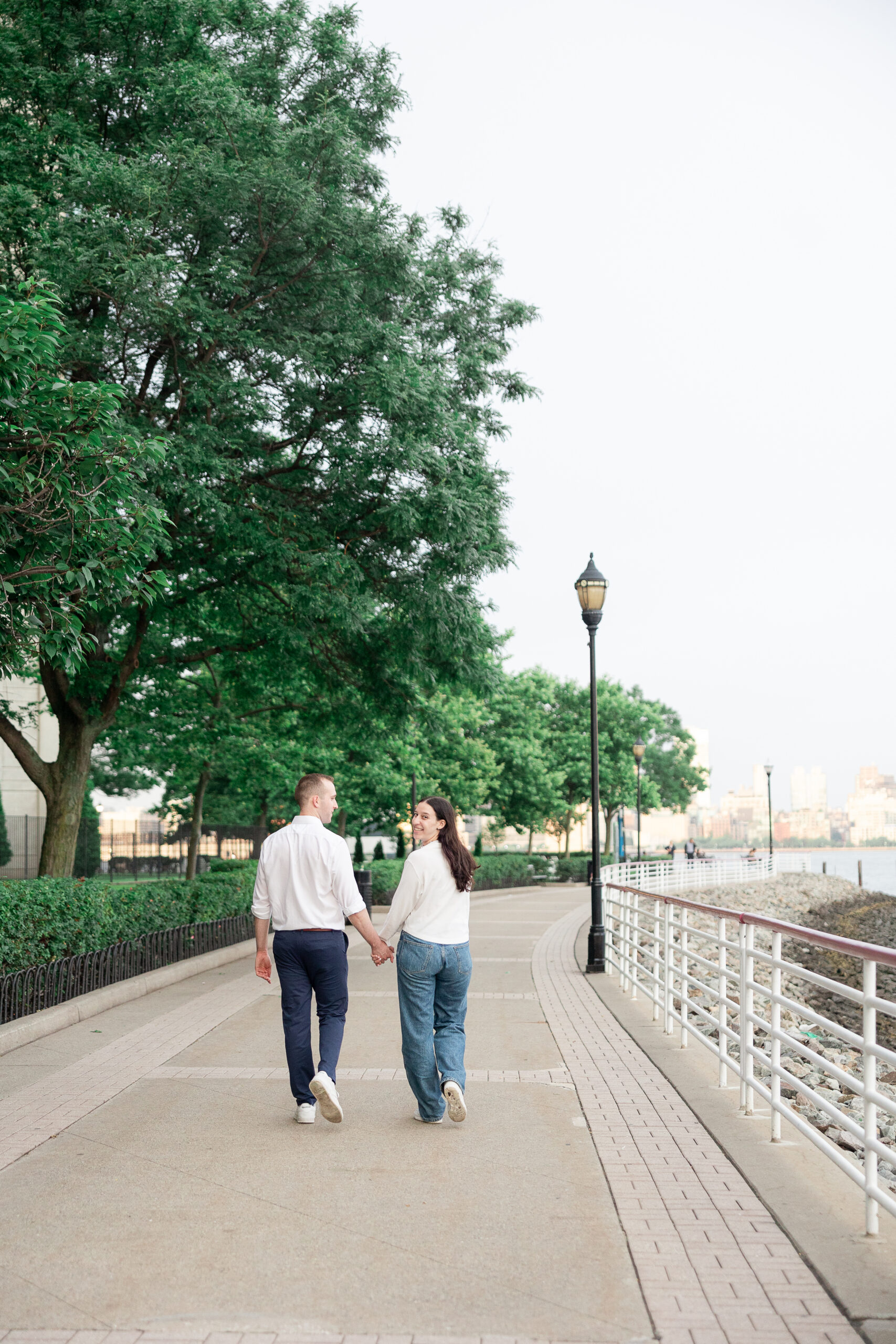 Fun piggy ride portraits of couple in Jersey City