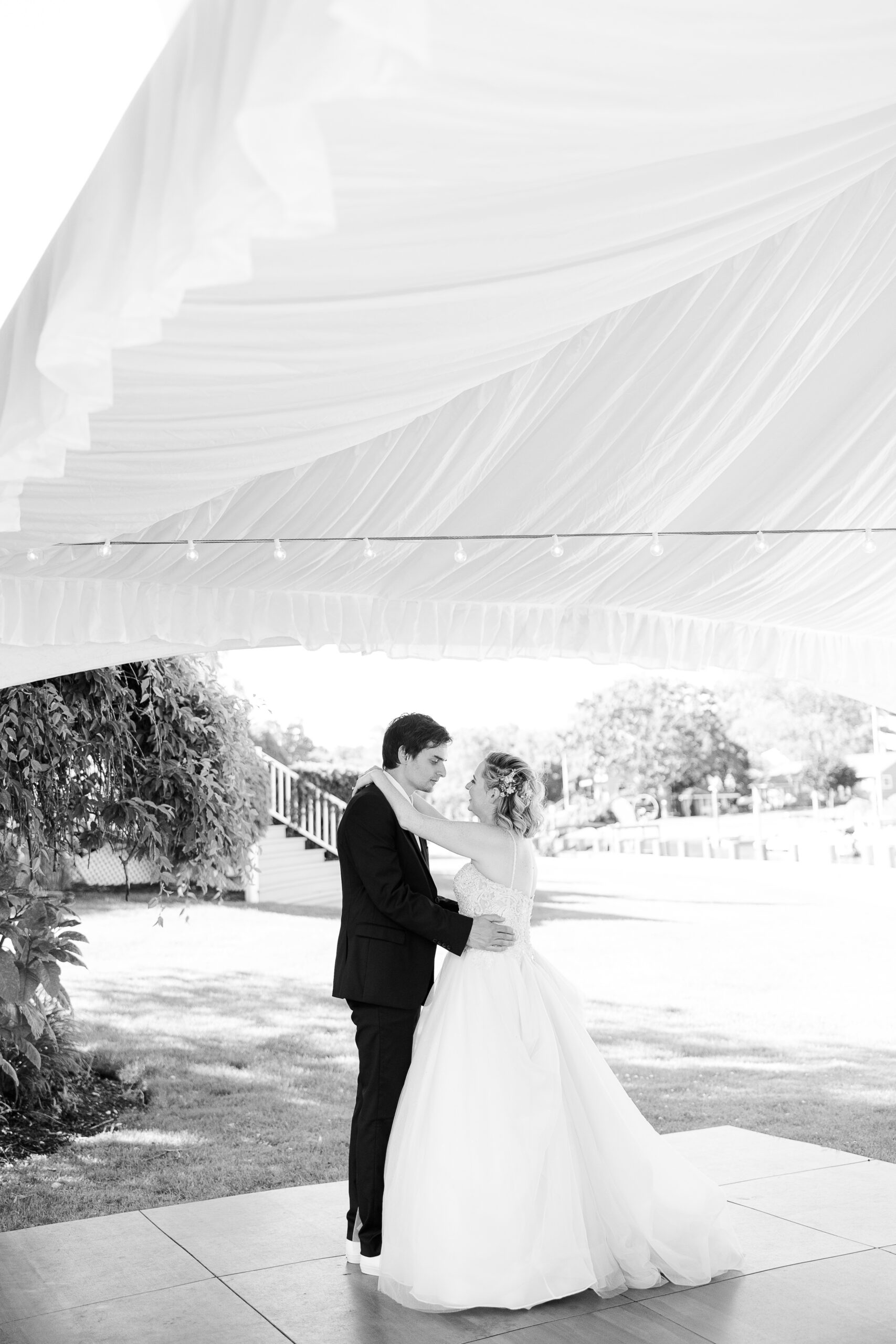Black and white moments for first dance in backyard wedding