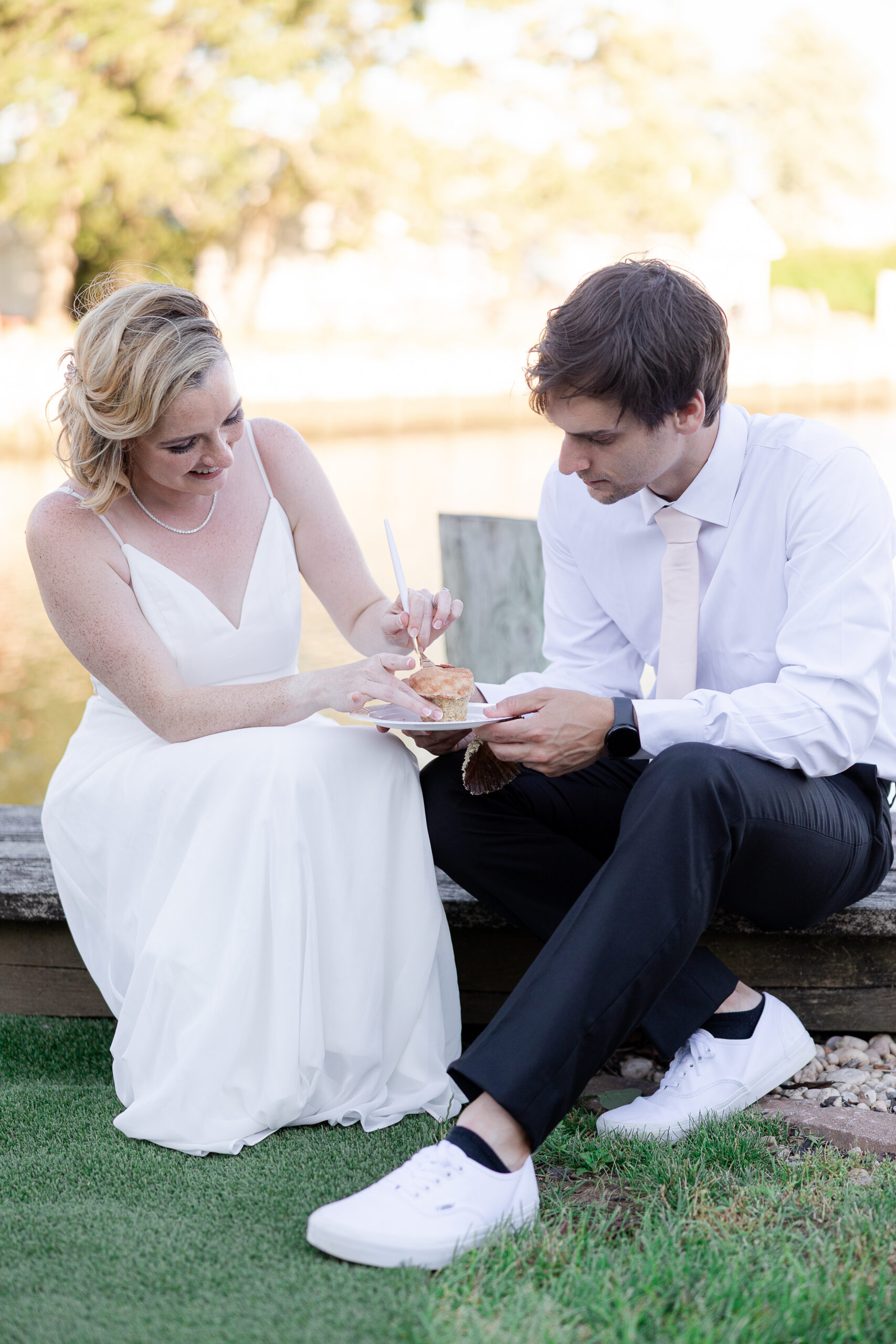 Casual cupcake cutting with bride and groom