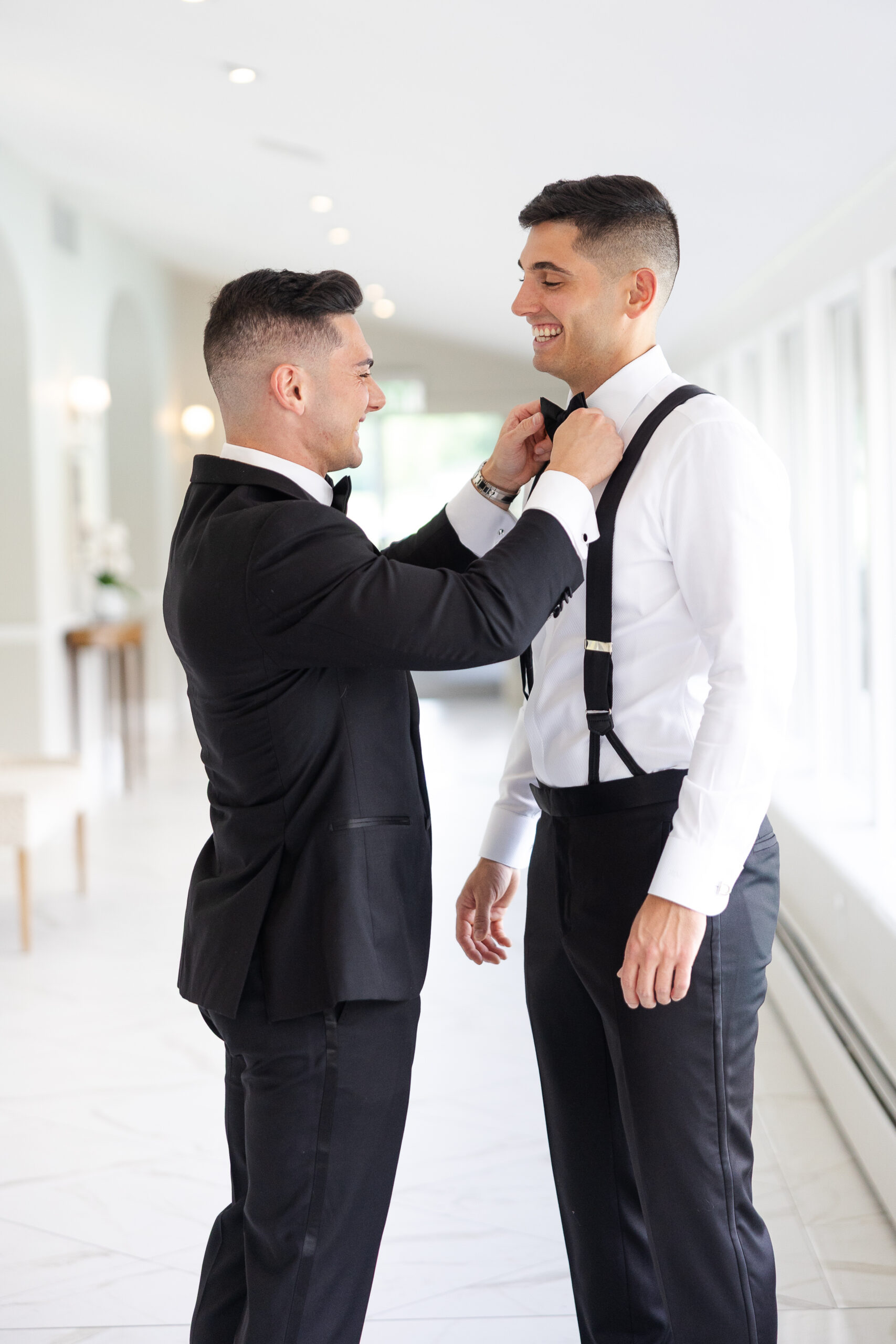Groom getting tie fixed by best man
