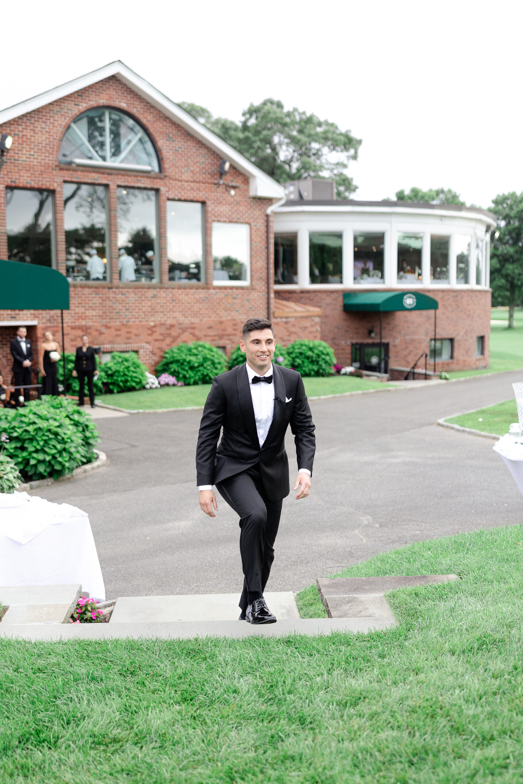Groom walking down the aisle at Brookville country club 