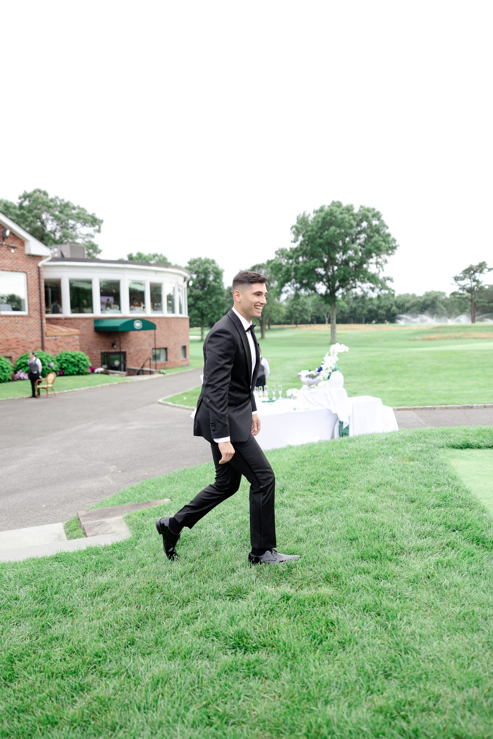 Groom walking down the aisle at Brookville country club 