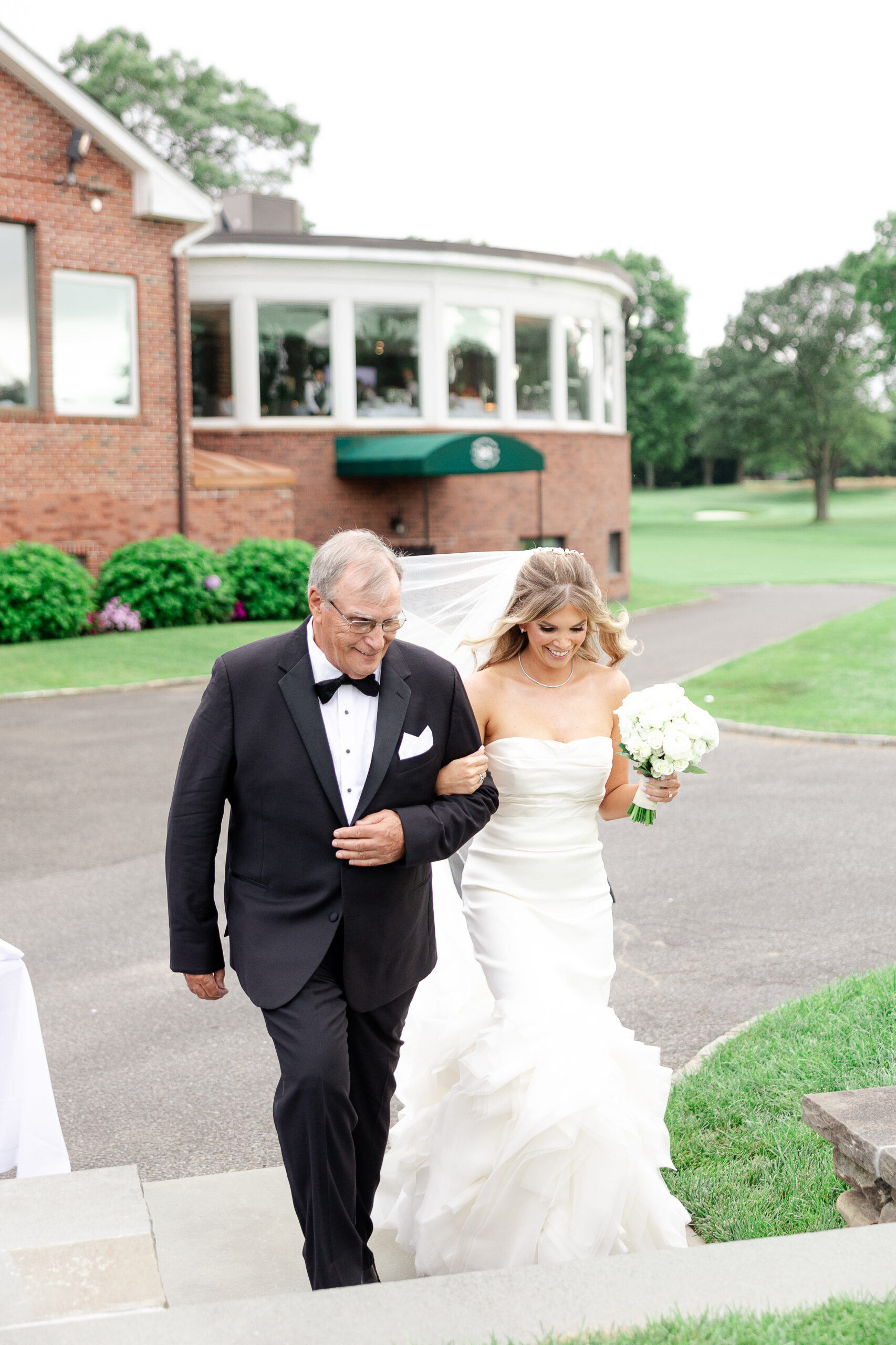 Bride walking down the aisle at Brookville country club 