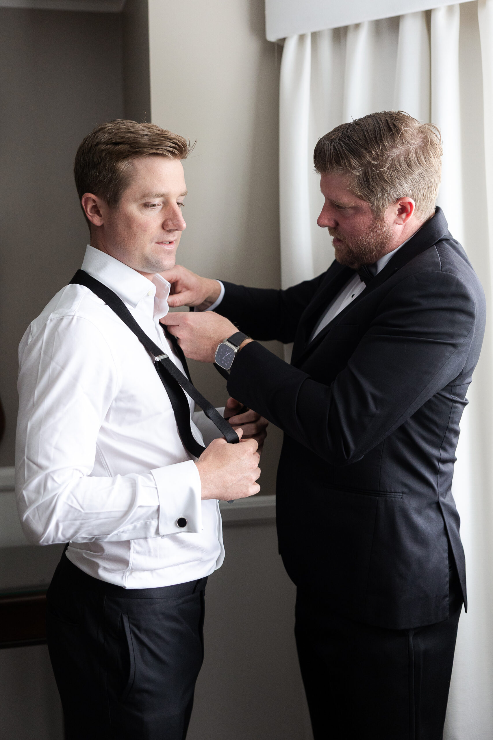 Groom getting dressed at Farmingdale NY wedding day
